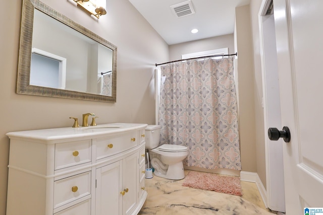 bathroom with vanity, toilet, and curtained shower