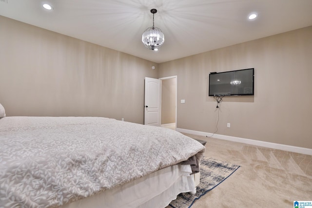 carpeted bedroom featuring a chandelier