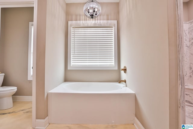 bathroom with a bath, a chandelier, and toilet