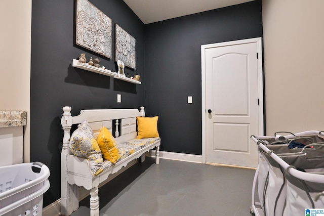 bedroom featuring concrete flooring