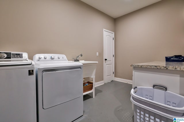 clothes washing area featuring washer and clothes dryer