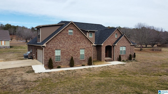 view of property with a garage, central AC unit, and a front yard