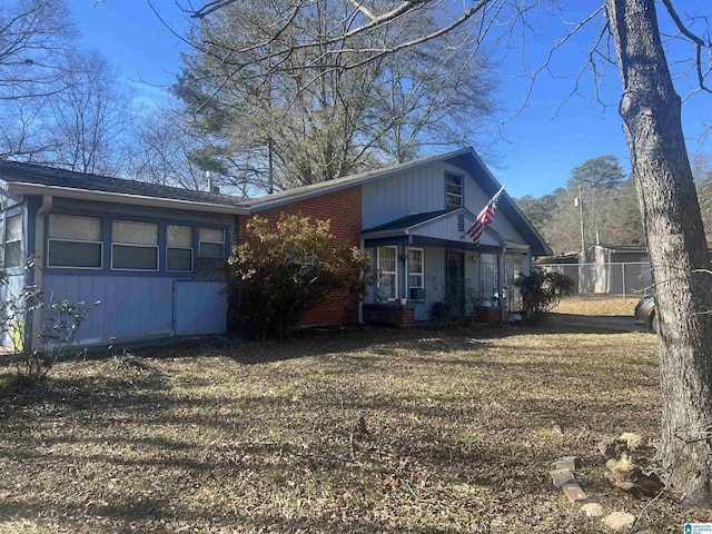 view of home's exterior featuring a yard and brick siding