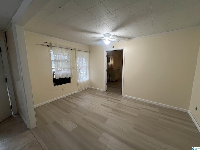 unfurnished room with light wood-type flooring, ceiling fan, and baseboards