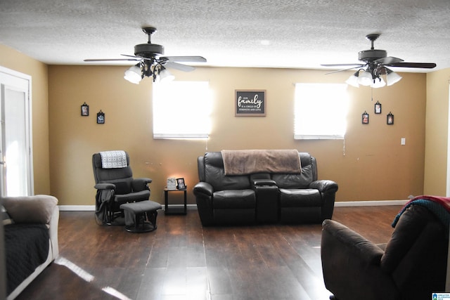 living room with plenty of natural light, a textured ceiling, and dark hardwood / wood-style flooring