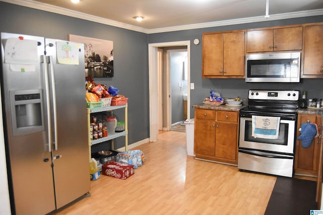 kitchen featuring stainless steel appliances, ornamental molding, and light hardwood / wood-style floors