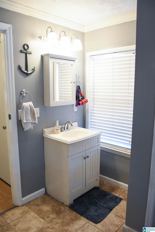 bathroom with crown molding, tile patterned floors, and vanity