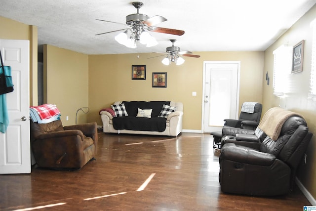 living room featuring dark wood-type flooring and a textured ceiling