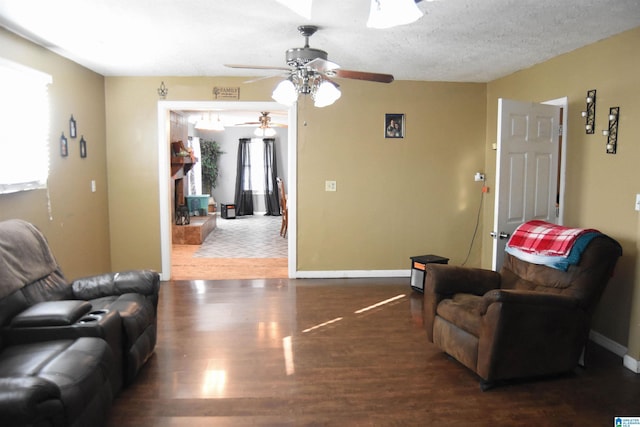 living room with dark hardwood / wood-style floors and a textured ceiling