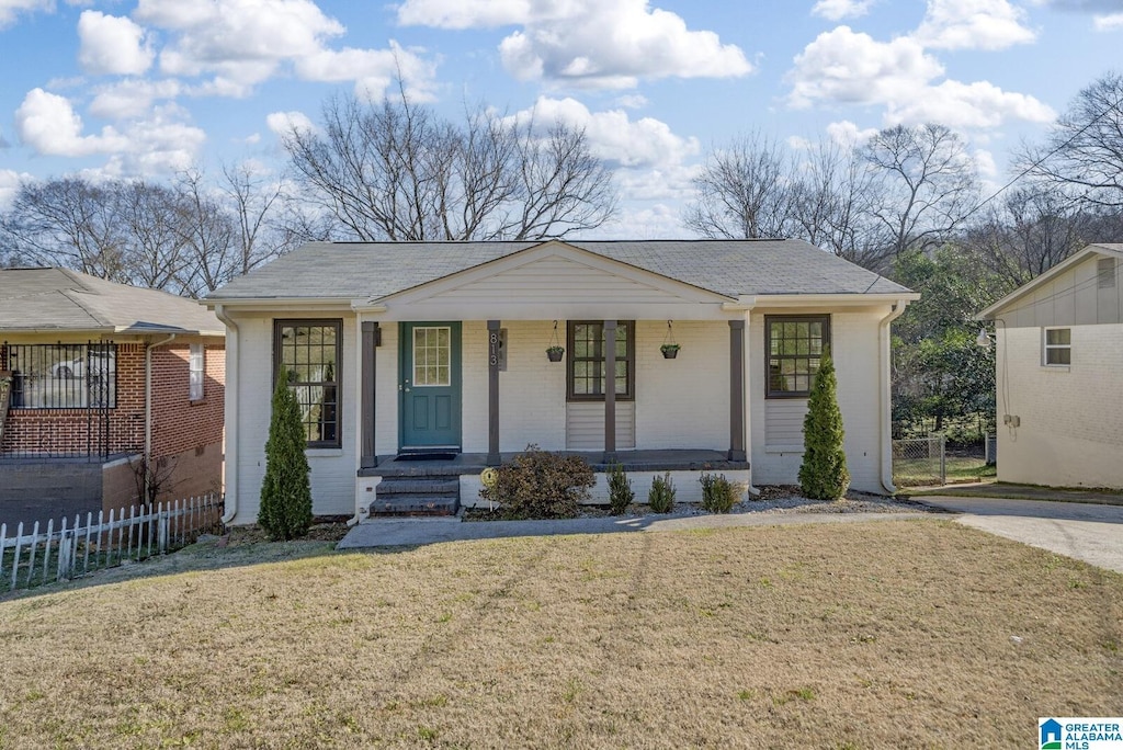 single story home with a front yard and a porch