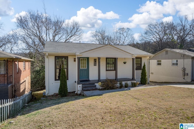 single story home with a porch and a front yard