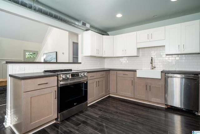 kitchen with sink, stainless steel appliances, dark hardwood / wood-style floors, white cabinets, and kitchen peninsula