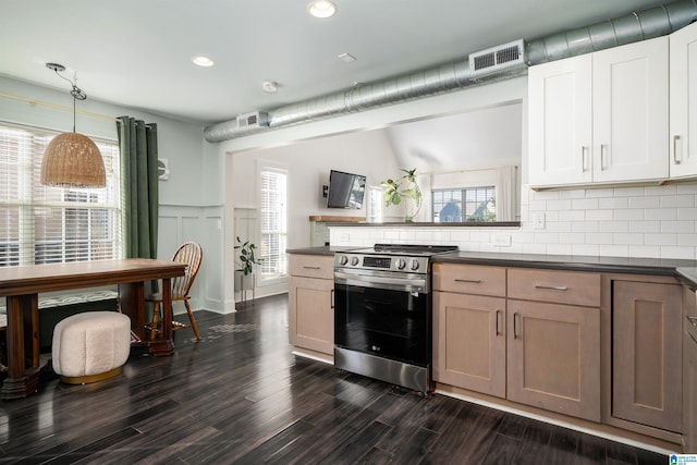 kitchen featuring stainless steel range with electric stovetop, hanging light fixtures, backsplash, white cabinets, and dark hardwood / wood-style flooring