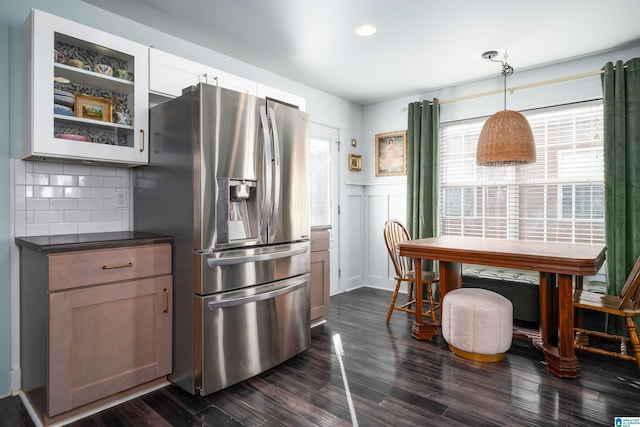 kitchen featuring pendant lighting, white cabinetry, tasteful backsplash, dark hardwood / wood-style flooring, and stainless steel fridge with ice dispenser