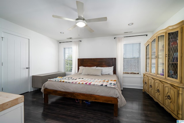 bedroom with dark hardwood / wood-style floors and ceiling fan