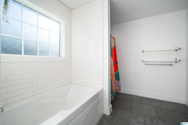 bathroom featuring tile patterned flooring and a bathtub