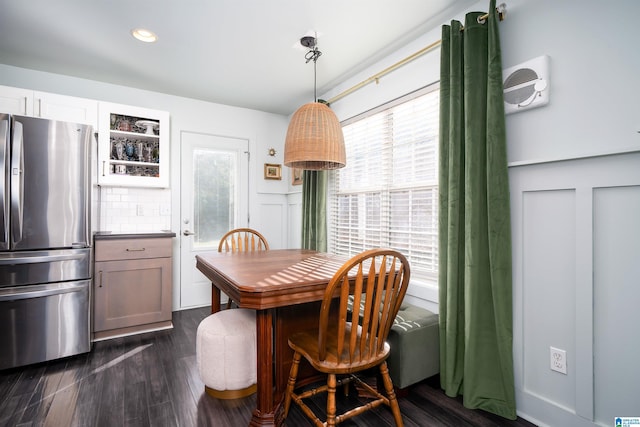 dining space with dark hardwood / wood-style floors and a healthy amount of sunlight