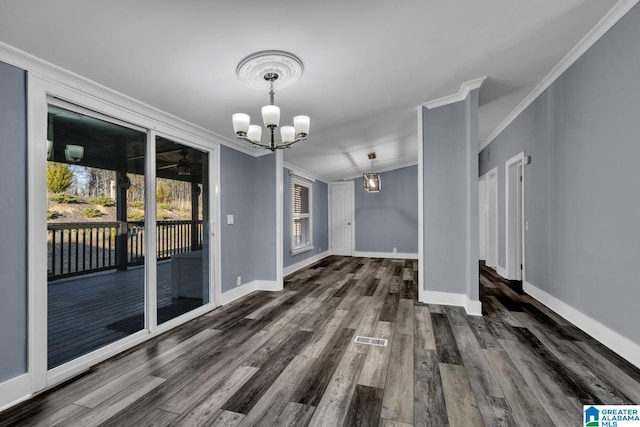 unfurnished dining area featuring ornamental molding, an inviting chandelier, and dark hardwood / wood-style flooring