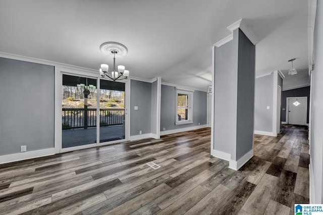 unfurnished dining area with ornamental molding, dark hardwood / wood-style floors, and a notable chandelier