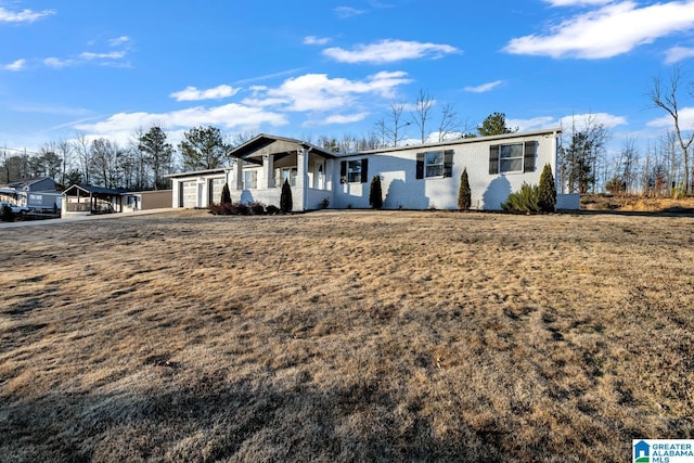 ranch-style home with a garage and a front yard