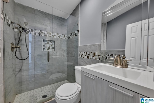 bathroom featuring vanity, tile walls, an enclosed shower, and toilet