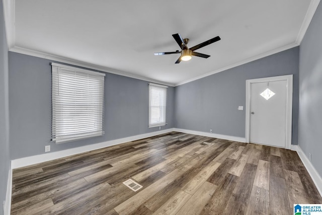 foyer entrance with ceiling fan, ornamental molding, wood-type flooring, and lofted ceiling