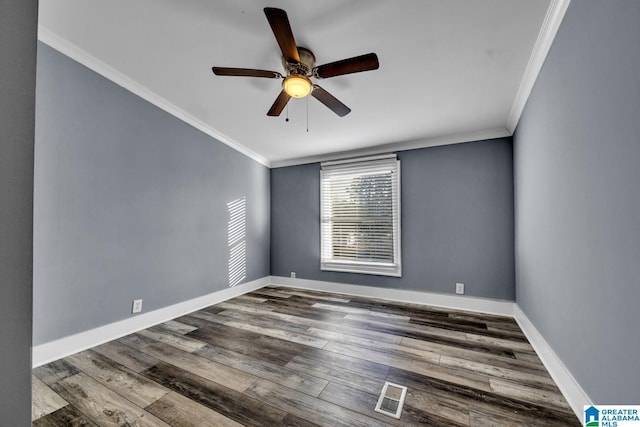 empty room featuring hardwood / wood-style flooring, ornamental molding, and ceiling fan