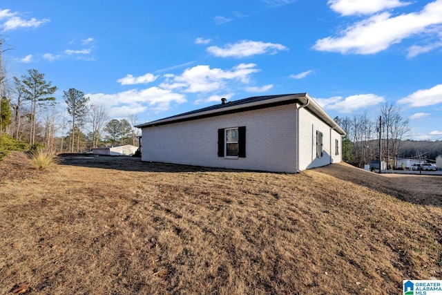 view of property exterior with a lawn