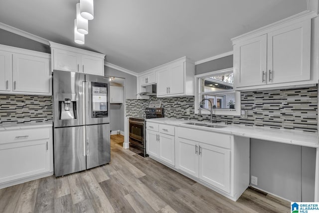 kitchen with white cabinetry, sink, and stainless steel appliances