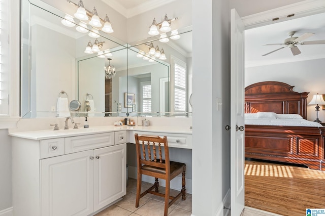 bathroom featuring crown molding, tile patterned floors, ceiling fan with notable chandelier, and vanity