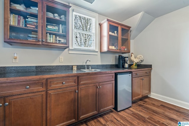 kitchen featuring dark hardwood / wood-style flooring, sink, and stainless steel fridge