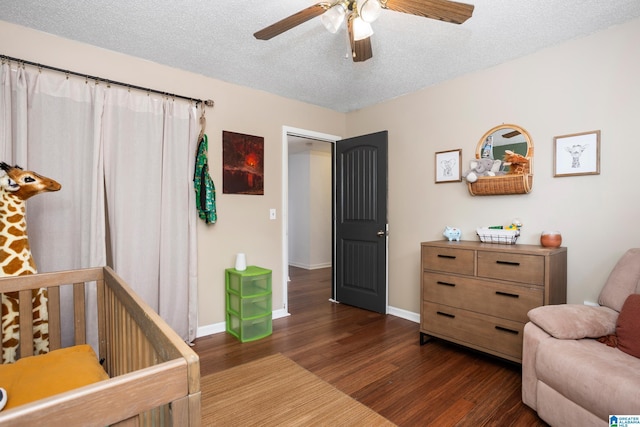 bedroom with ceiling fan, dark hardwood / wood-style floors, and a textured ceiling