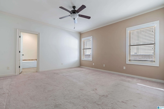 carpeted spare room featuring crown molding and ceiling fan