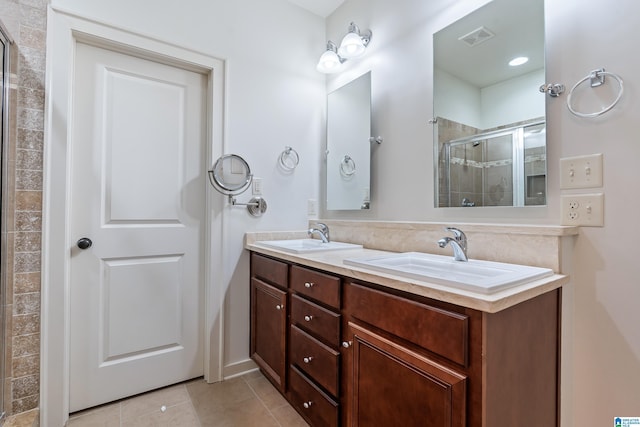 bathroom with vanity, tile patterned flooring, and a shower with shower door