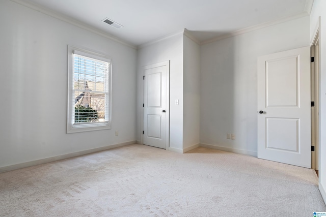 unfurnished bedroom featuring crown molding and light carpet