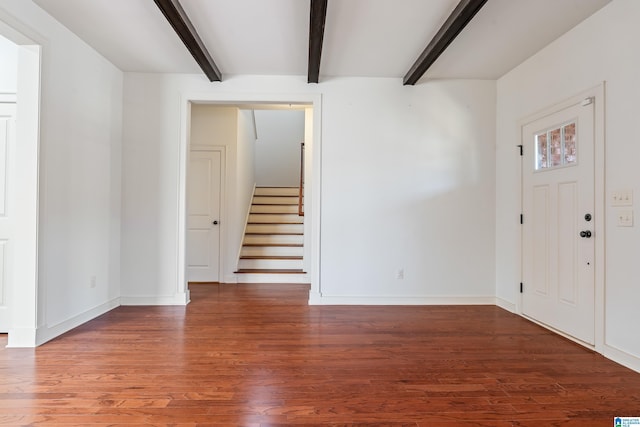 entryway with beamed ceiling and wood-type flooring