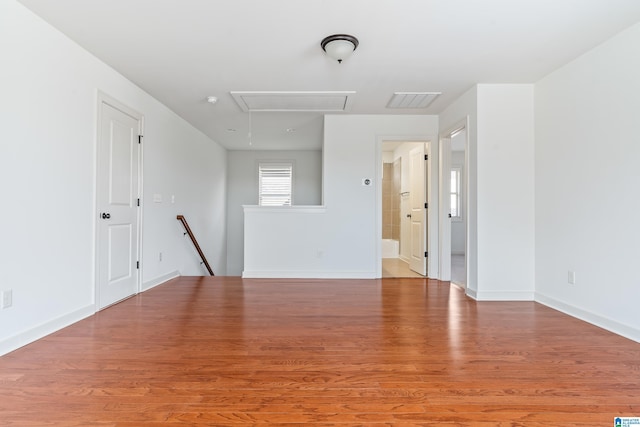 unfurnished room with wood-type flooring