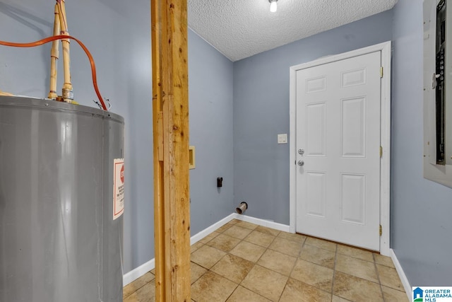 laundry room with water heater and a textured ceiling