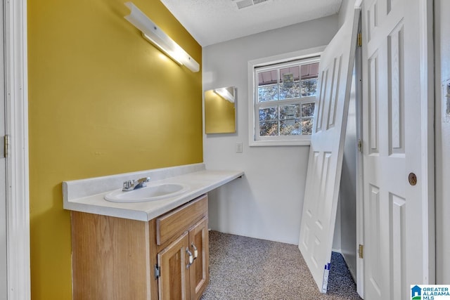 bathroom with vanity and a textured ceiling