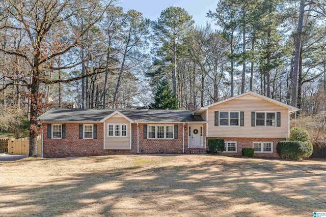 tri-level home with a front yard