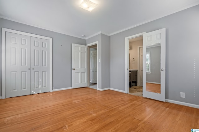 unfurnished bedroom with ornamental molding, light hardwood / wood-style floors, and a closet