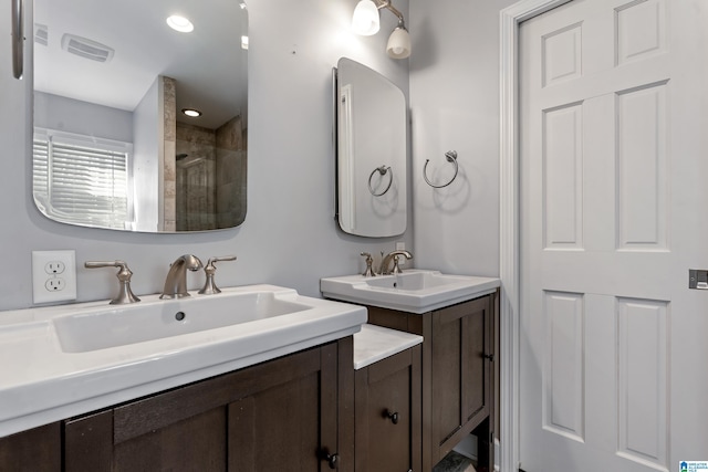 bathroom featuring vanity and a shower with door