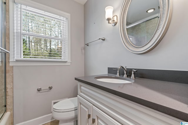 full bathroom with vanity, combined bath / shower with glass door, and toilet