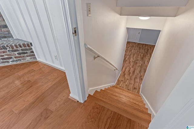 staircase with wood-type flooring