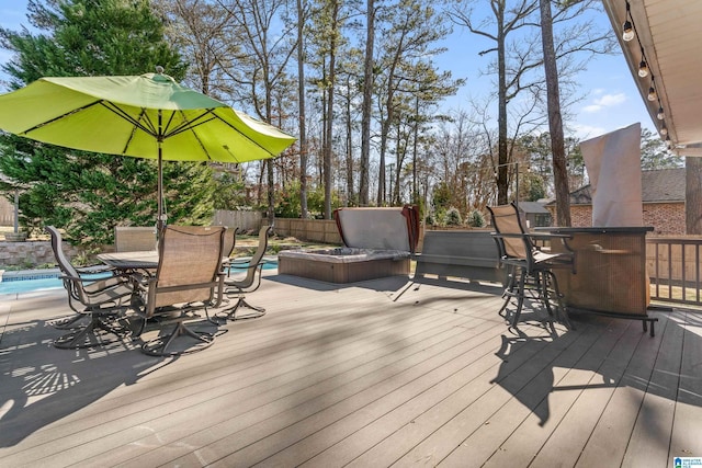 deck featuring a pool and a bar