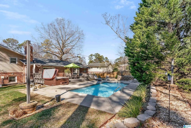 view of pool featuring a hot tub and a patio area