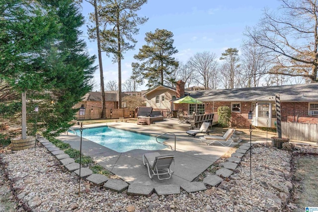 view of pool with a jacuzzi and a patio