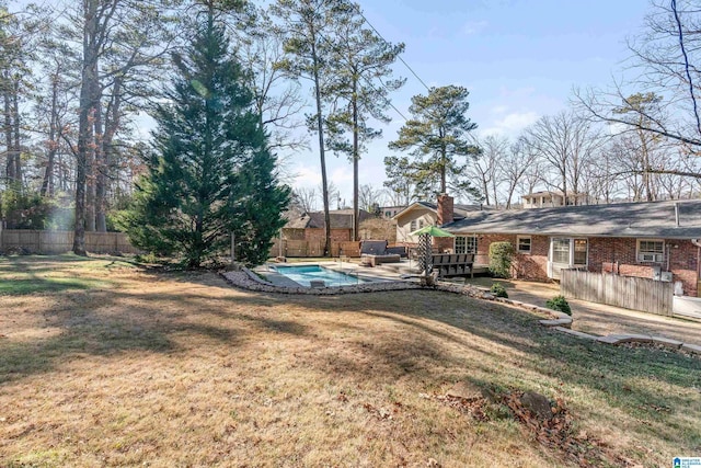 view of yard featuring a fenced in pool and a patio