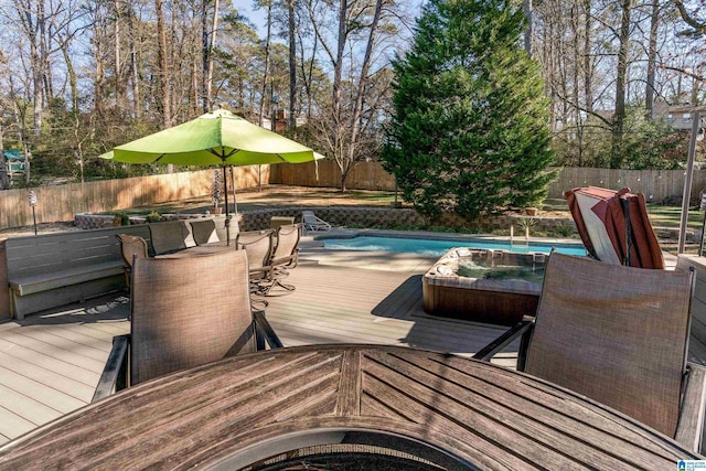 wooden terrace with a fenced in pool