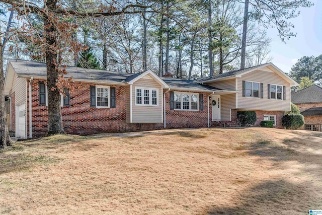 view of front of home with a garage and a front lawn